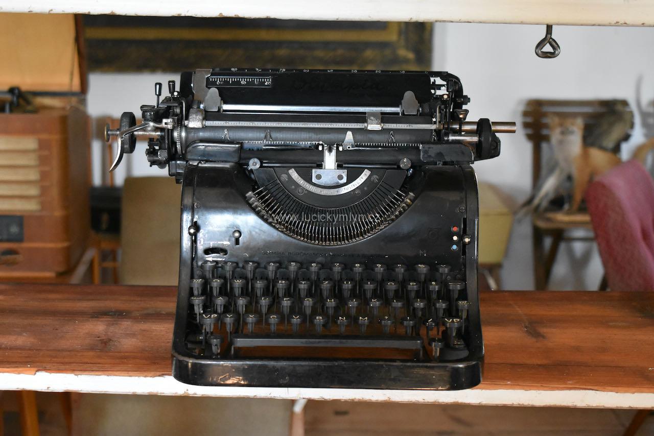 Starožitný psací stroj z první poloviny 20. stol. s méně čitelným označením výrobce Olympia Starožitný psací stroj z první poloviny 20. stol. s méně čitelným označením výrobce Olympia