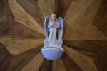 Starožitná porcelánová kropenka s okřídleným andílkem a mušlovou nádobkou.
