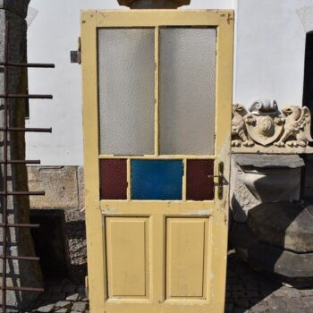 Starožitné rámové dveře se secesními kazetami a barevnými prosklenými poli z počátku 20. století.