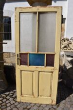 Starožitné rámové dveře se secesními kazetami a barevnými prosklenými poli z počátku 20. století.