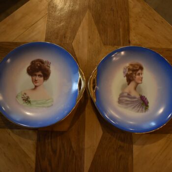 Pár starožitných secesních porcelánových talířů s portréty dam a zlatými uchy.
