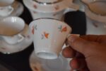 Starožitný porcelánový kávový servis ART-DECO pro 10 osob s květinovým dekorem a zlatou linkou.