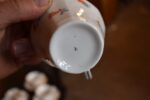 Starožitný porcelánový kávový servis ART-DECO pro 10 osob s květinovým dekorem a zlatou linkou.